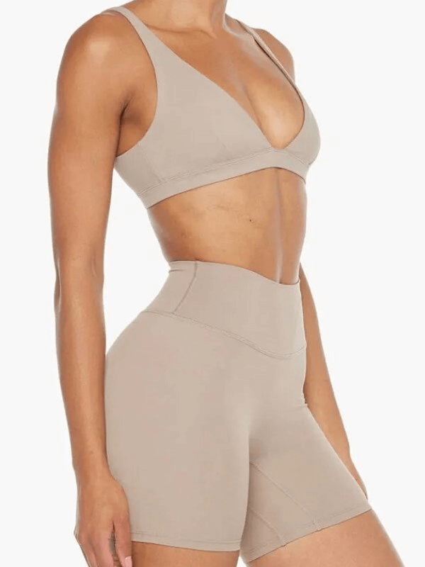 Breathable elastic women's shorts and sports bra suit, high-quality nylon in a solid, form-fitting design for yoga or workouts.